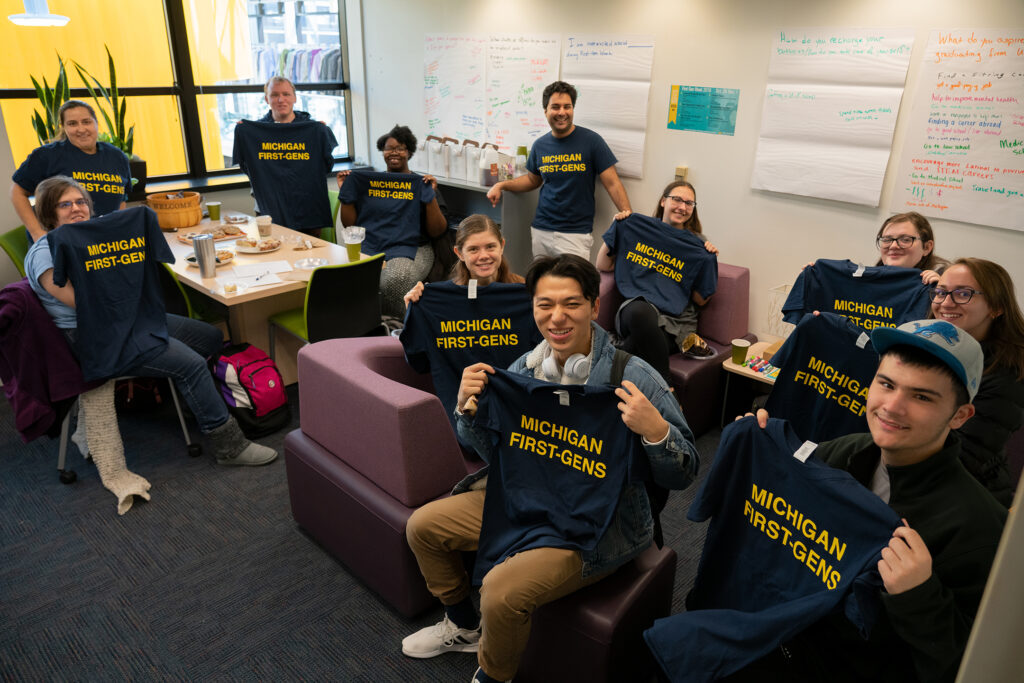 first-gen students holding t-shirts