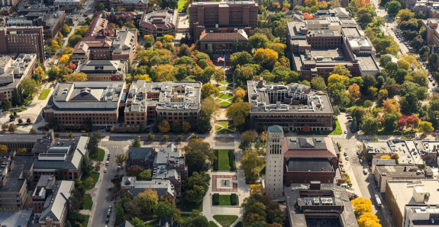 Campus aerials shot on Homecoming weekend during the Illinois game: Burton Tower, Alumni Center, Michigan League, Chemistry Building, SNRE, Randall Lab, Hatcher Graduate Library , Kraus Natural Science