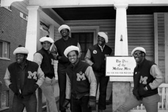 Michigan football players pose in front of their off-campus house.