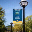 Culture Journey banner on a light pole against a blue sky.