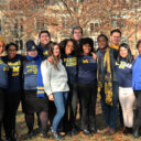 group of MCAC advisers wearing Michigan gear outside in the fall.