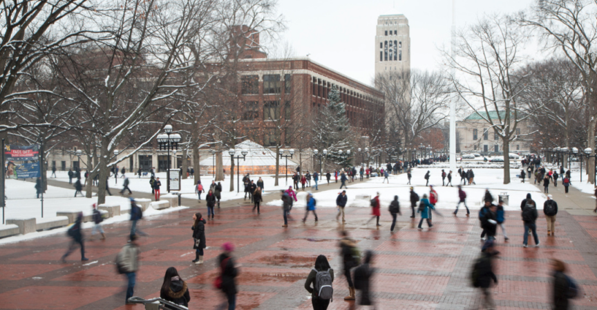 students walking across campus near Burton Tower